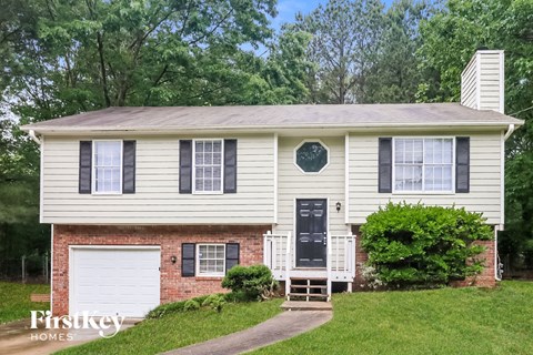 a white house with black shutters and a black door