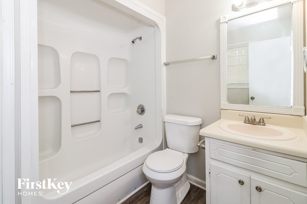 a bathroom with a sink toilet and a bath tub