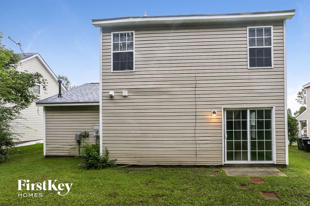 a side view of a house with a garage and a window