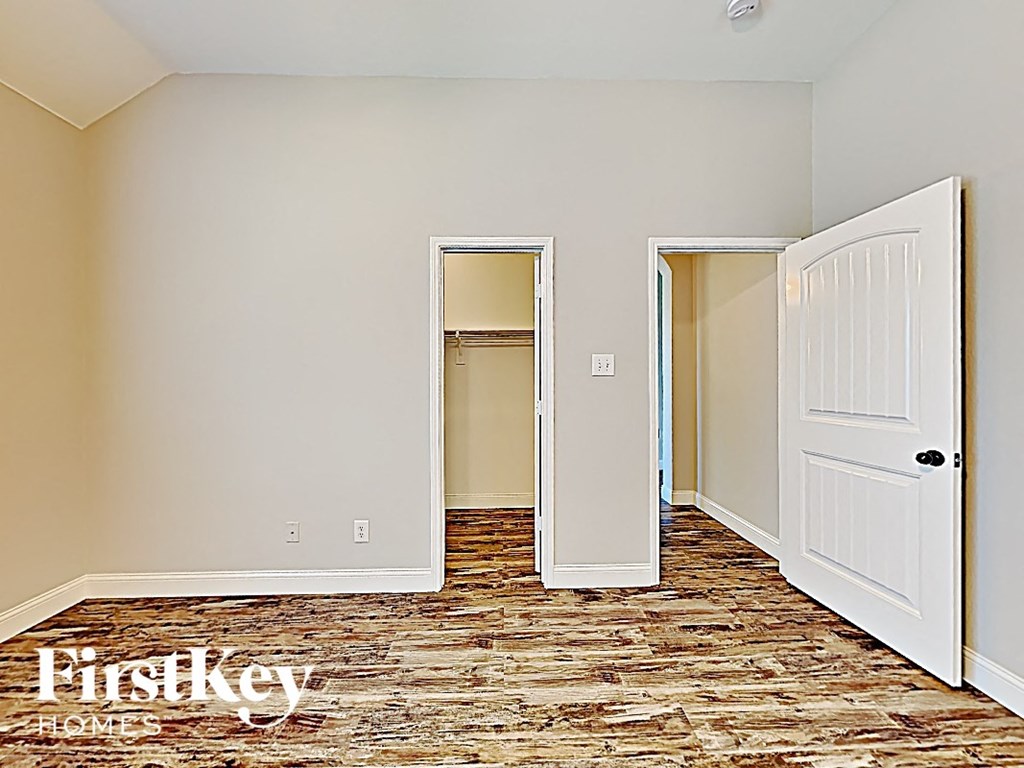 a bedroom with an open door and a closet