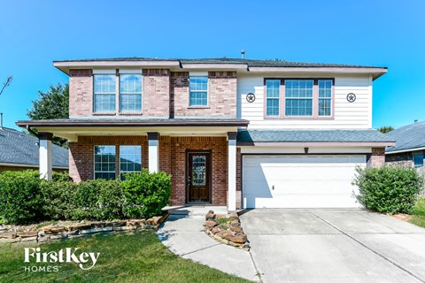 a large brick house with a white garage door