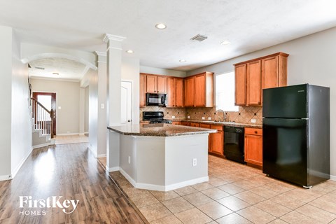 a kitchen with black appliances and wooden cabinets