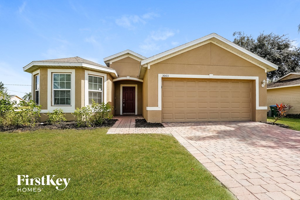A two-story house with a garage is for sale by FirstKey Homes.