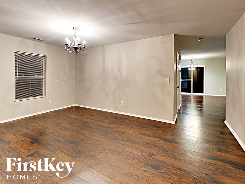 A room with wooden floors and a chandelier is on the market with FirstKey Homes.