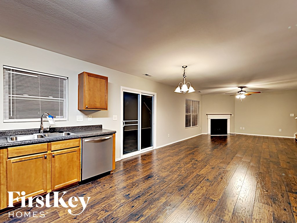 A kitchen with wooden floors and a FirstKey Homes logo.