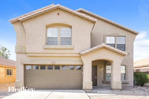 a beige house with a garage door