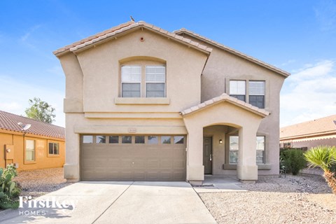 a house with a garage door in front of it