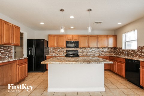 a kitchen with wooden cabinets and a counter top