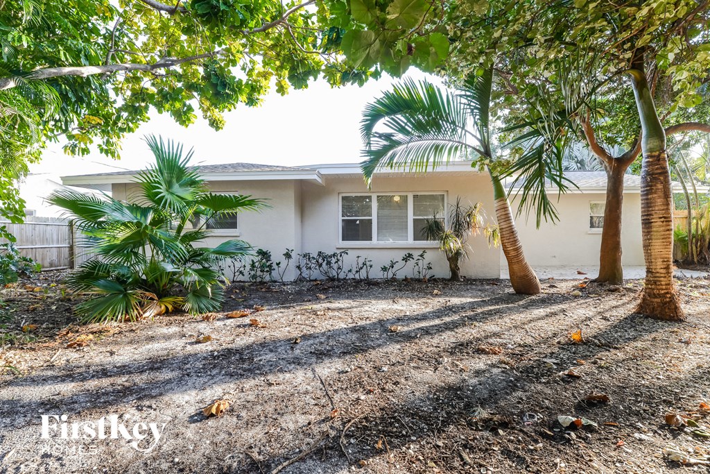 a house with palm trees in front of it