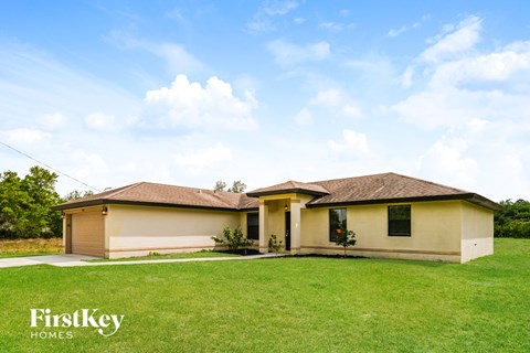 a house with a lawn and a blue sky