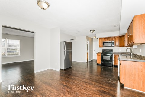 A kitchen with wooden cabinets and a black oven.