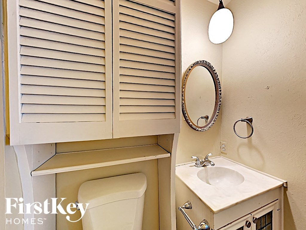 a small bathroom with a sink and a toilet and a mirror