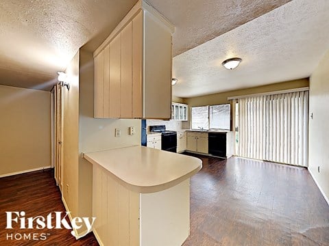 a kitchen with white cabinets and a white counter top