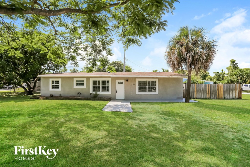 A house with a lawn in front of it.