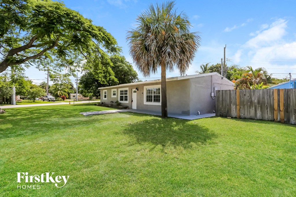 A house with a palm tree in front of it.