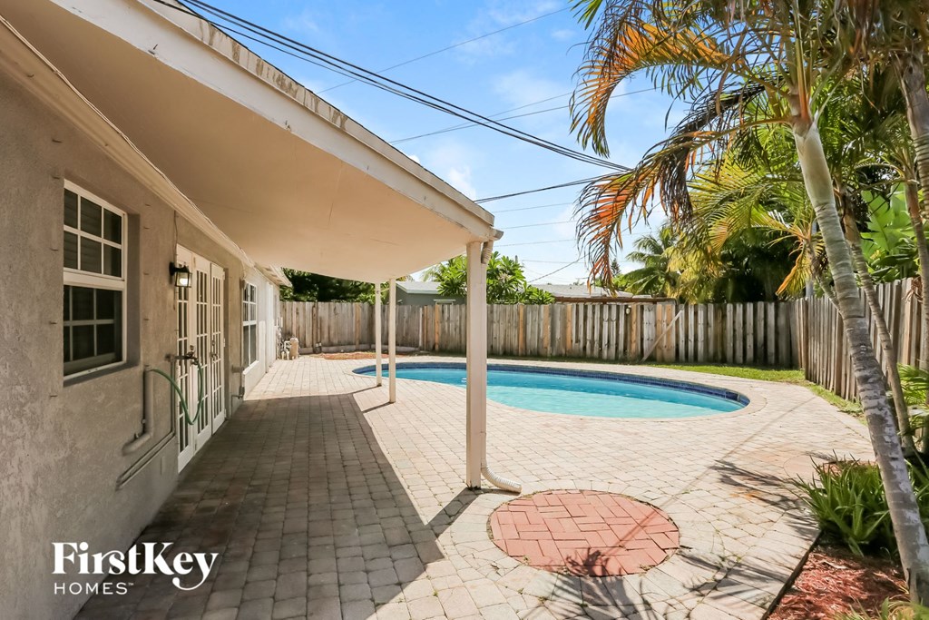A house with a pool in the backyard.
