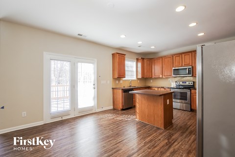 A kitchen with wooden cabinets and a refrigerator.