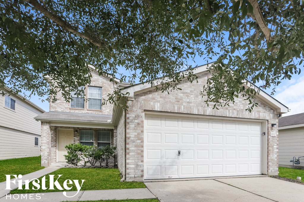 a white brick house with a white garage door