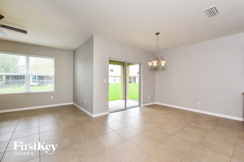 an empty living room with a sliding glass door to the yard