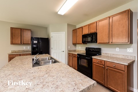 a kitchen with black appliances and granite counter tops