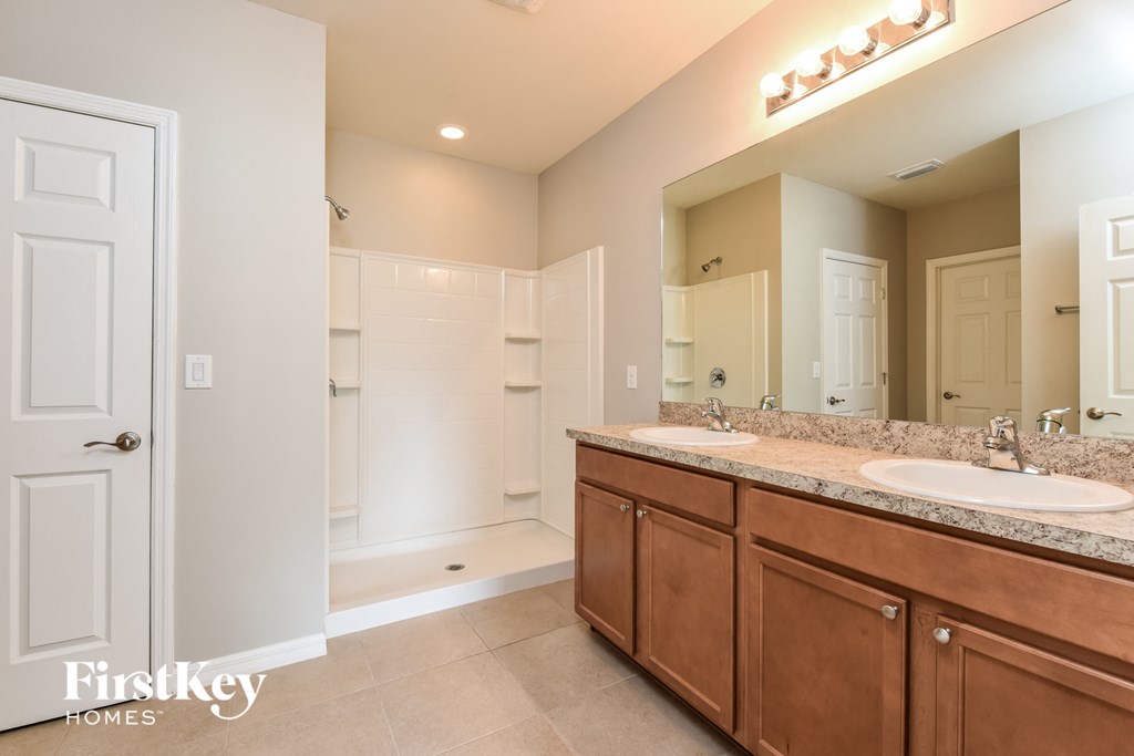 a bathroom with two sinks and a large mirror