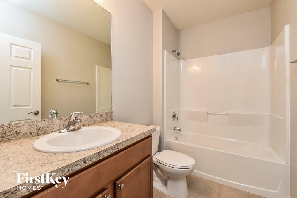a bathroom with a sink toilet and a shower