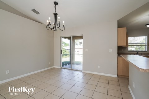 an empty kitchen and living room with a sliding glass door