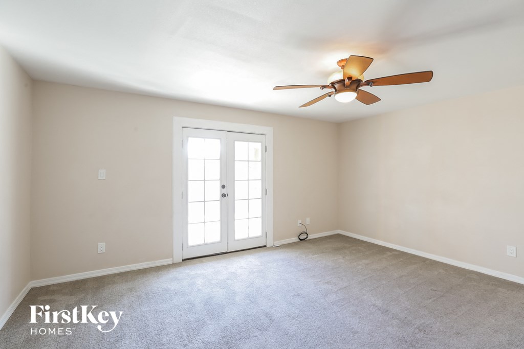 the master bedroom is spacious and has a ceiling fan