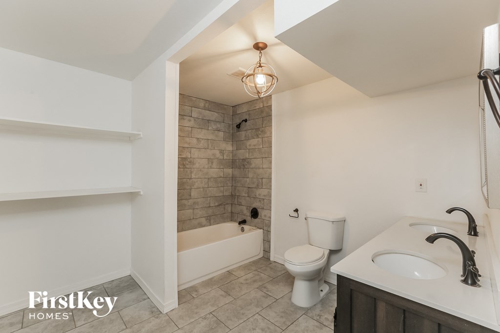 a bathroom with a toilet and a sink and a tub