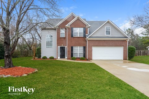 a home with a driveway and a lawn