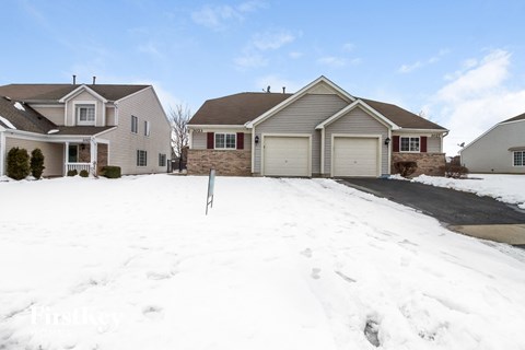 a snow covered driveway in front of a house