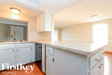 a kitchen with white cabinets and a white counter top