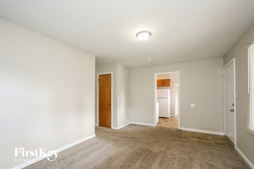 a master bedroom with carpeted flooring and white walls