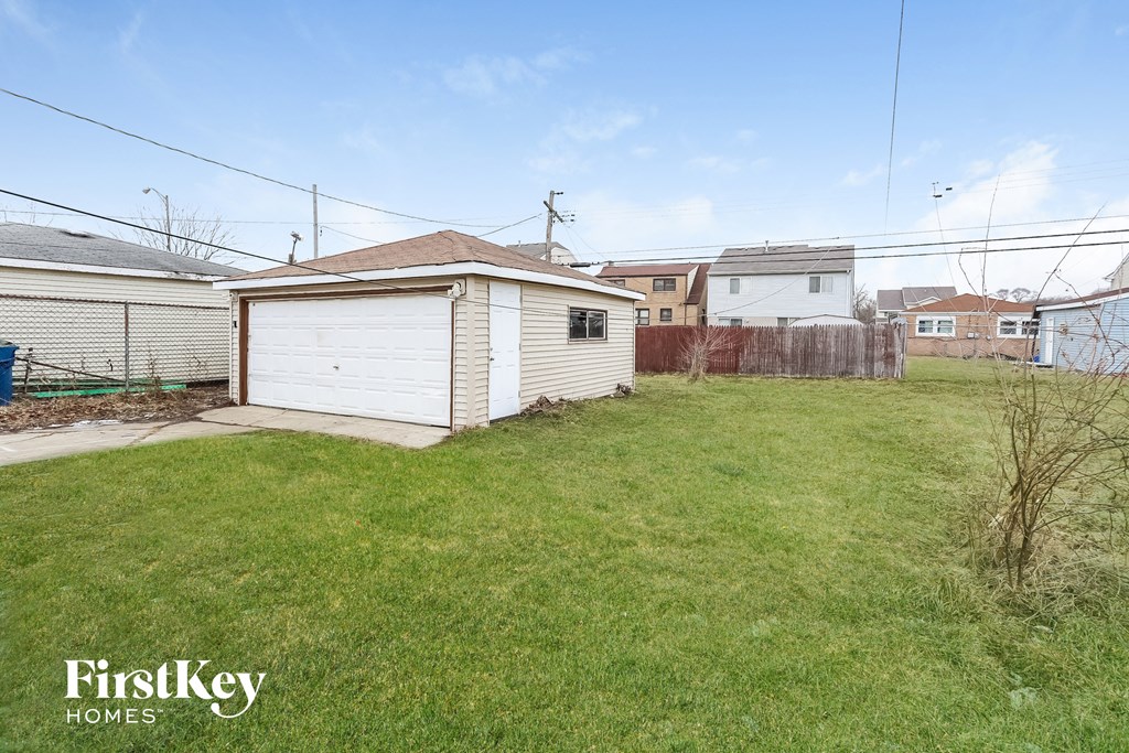 a backyard with a shed and a yard with grass and a fence