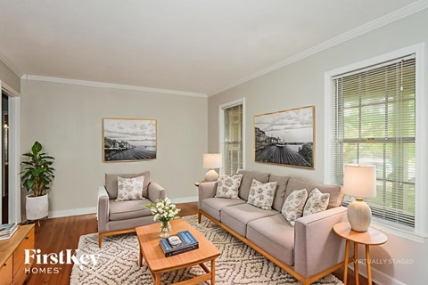 A living room with a couch, chair, and coffee table.