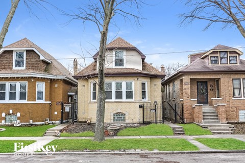a group of houses on a street with trees