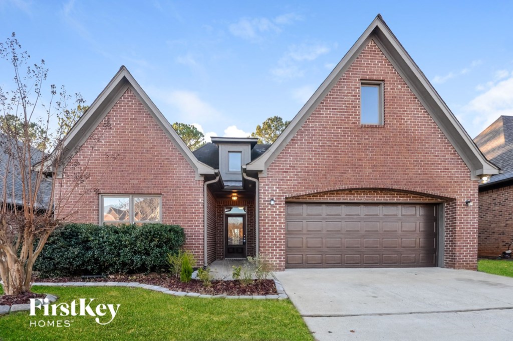 front view of a brick house with a garage door