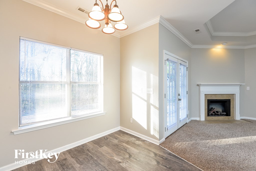 a living room with a fireplace and a chandelier