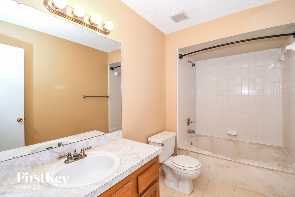 a bathroom with a sink toilet and a shower