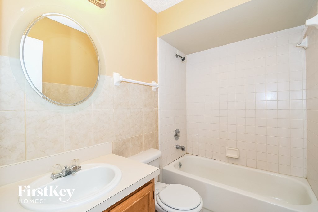 a bathroom with a sink toilet and a bath tub