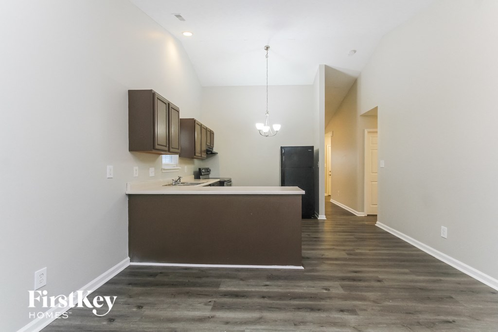 A kitchen with a brown counter and cabinets.