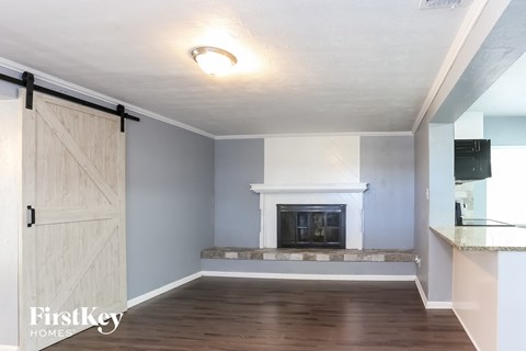 a living room with a fireplace and a barn door
