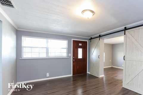 the living room of a home with a door and a window