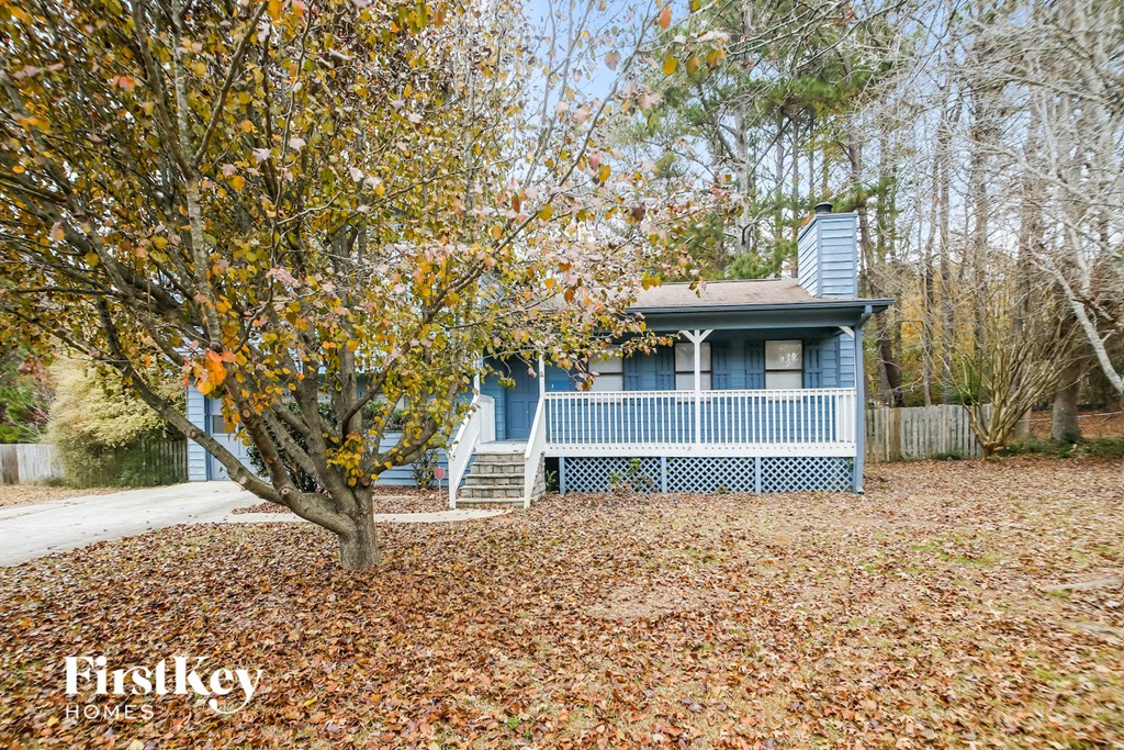 A blue house with a tree in front of it.