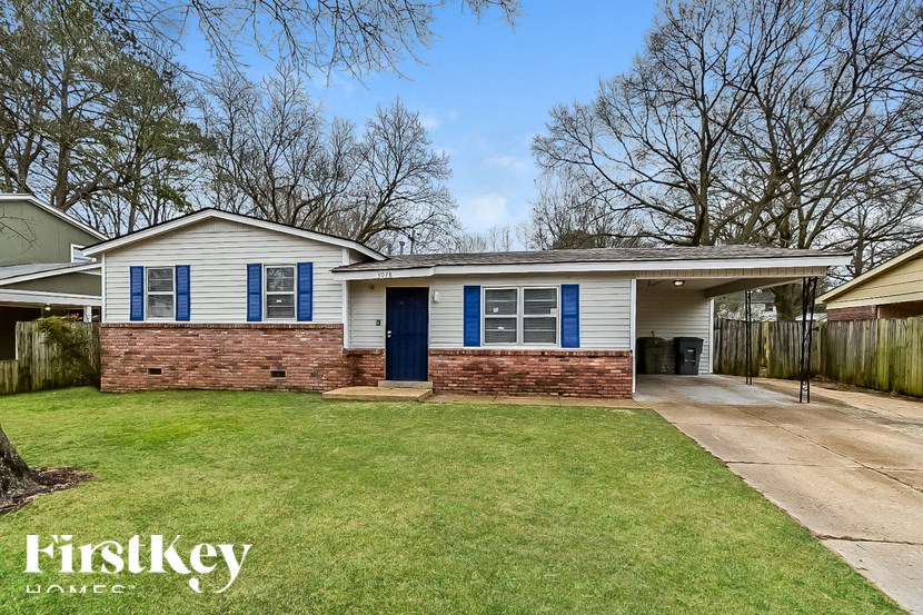 A house with a blue door and windows is for sale.