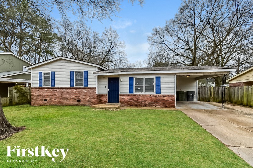 A house with a blue door and windows is for sale.