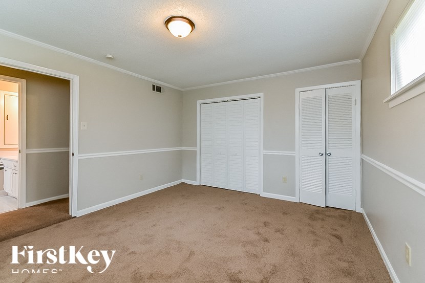 A room with a carpeted floor and white walls.