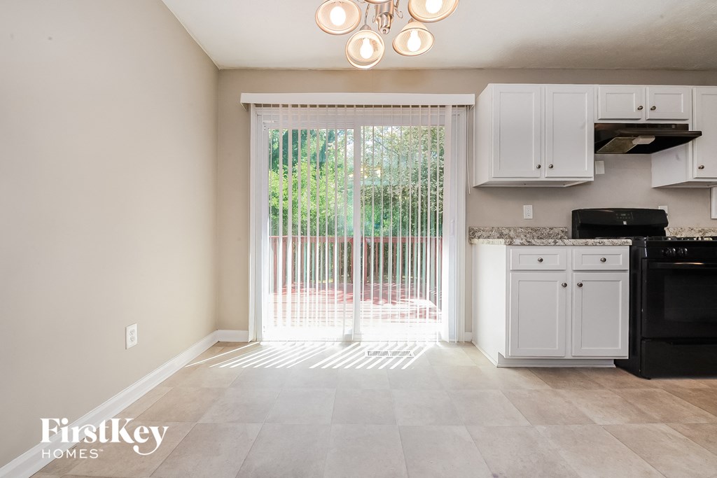 an empty kitchen with a sliding glass door to a patio