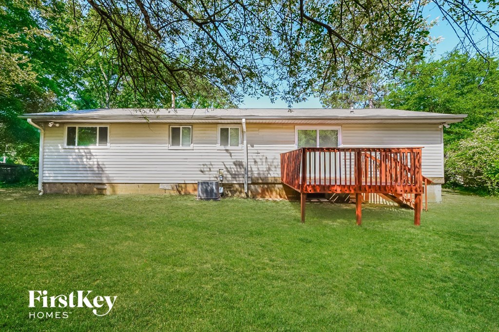 a mobile home in a backyard with a wooden deck
