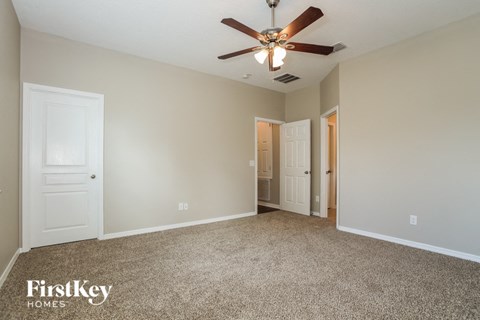 the living room of a house with a ceiling fan